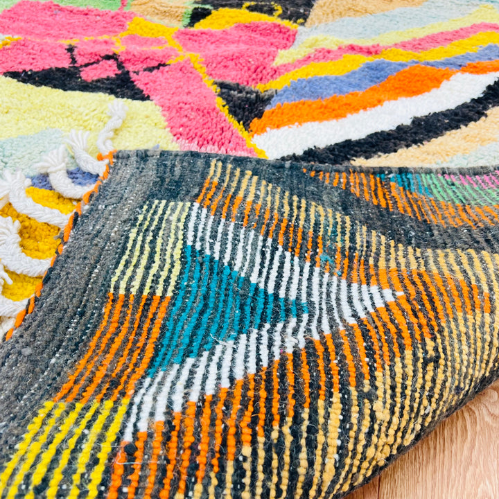 Colorful Chevron Moroccan Rug with bold zigzag pattern, handcrafted by Berber women, featuring vibrant colors and traditional Moroccan design.
