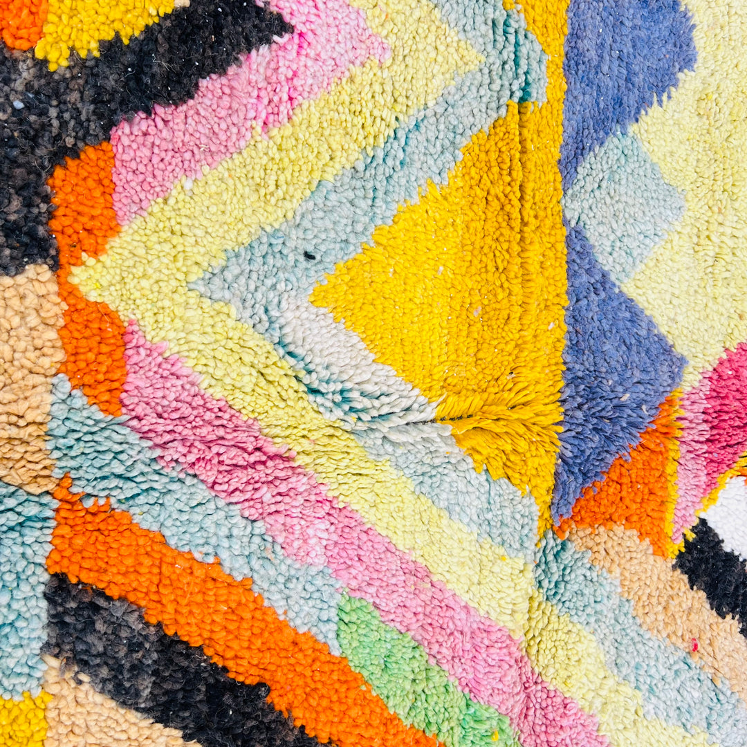 Colorful Chevron Moroccan Rug with zigzag pattern featuring orange, pink, green, yellow and blue, traditional Berber design.