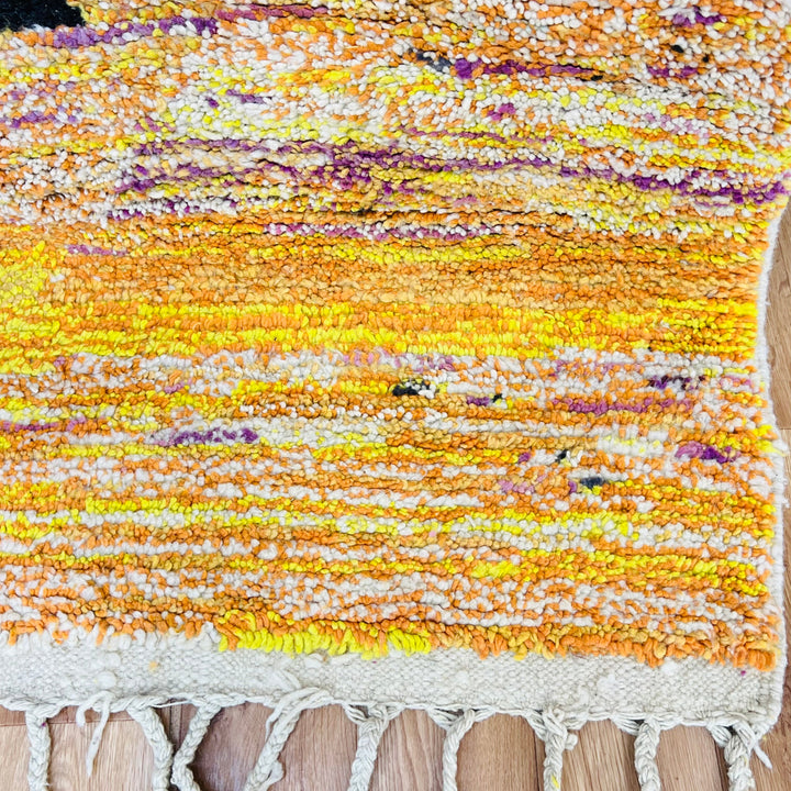 Vintage Moroccan Sunset Rug with vibrant yellow, orange, and purple hues, depicting desert patterns. Handmade Moroccan wool rug.