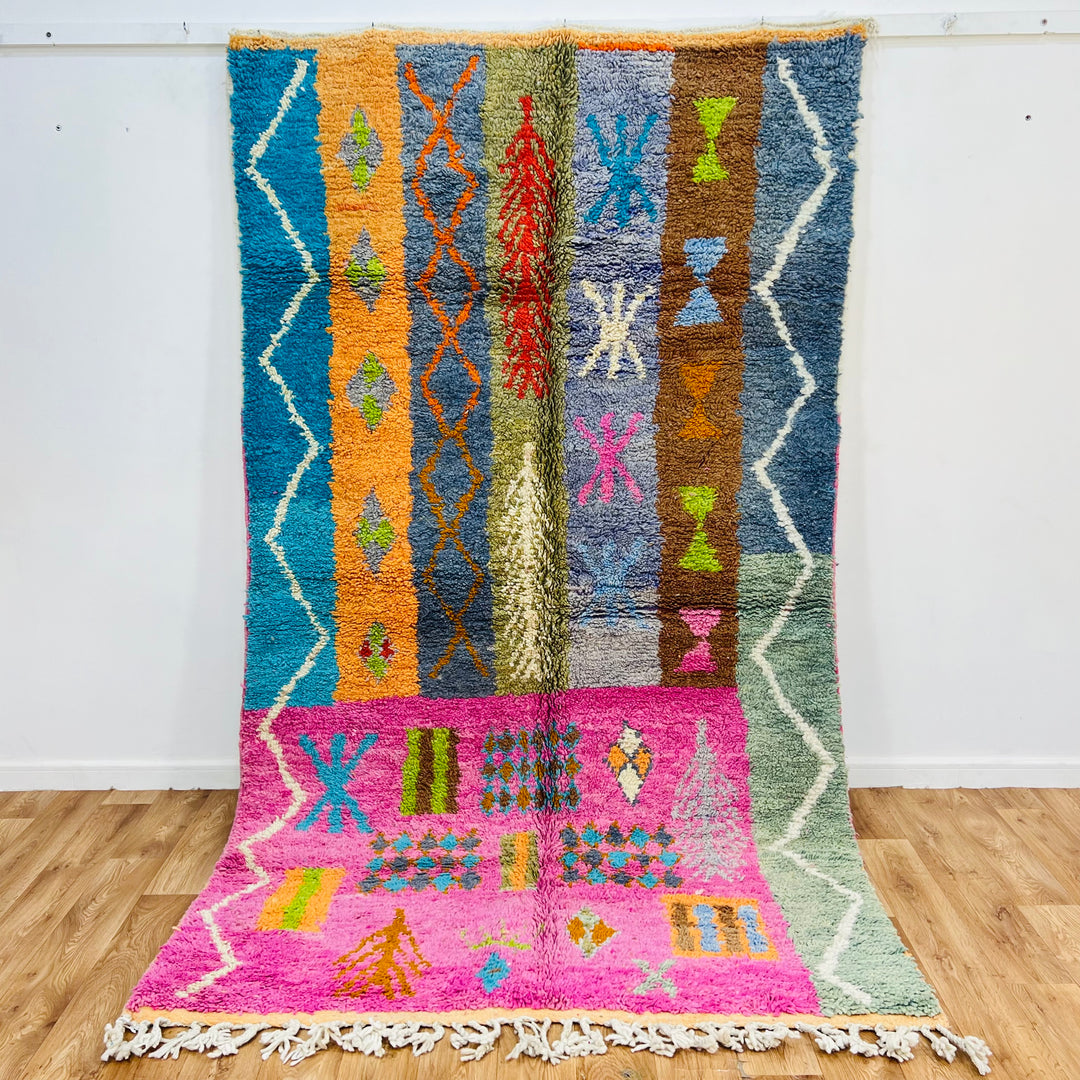Colorful Berber Moroccan rug with tribal patterns in pink, orange, and blue, handmade with premium wool; 9x5 ft area rug.