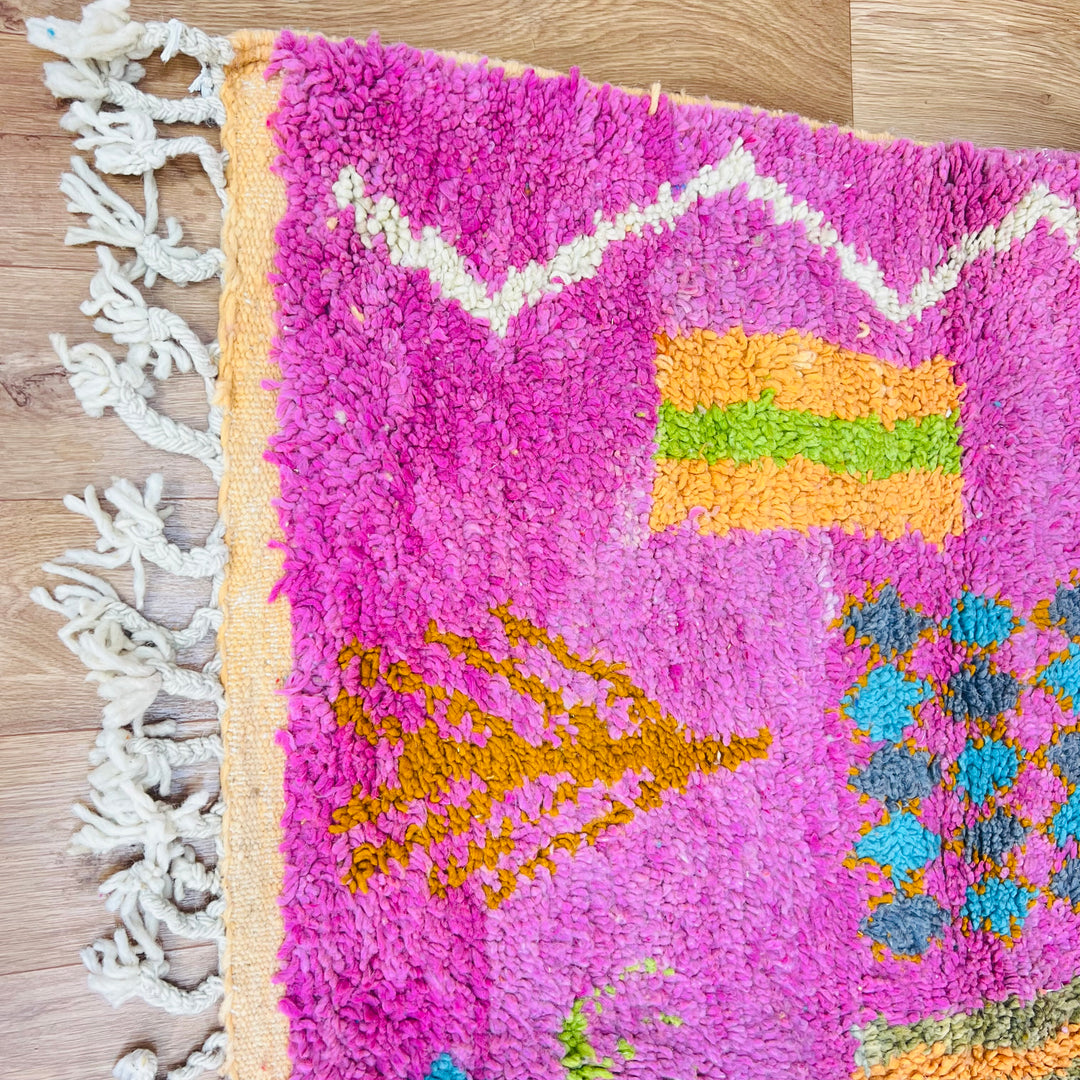 Colorful handmade Berber Moroccan rug with pink and orange tribal patterns, 9x5 ft. Premium wool. Perfect for living room.