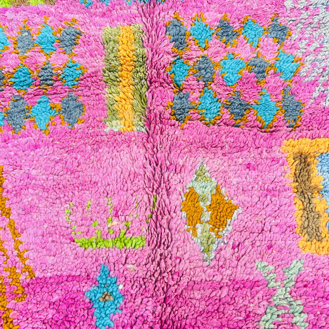 Colorful Berber Moroccan rug with pink, orange, and blue tribal patterns. Handmade wool area carpet for sale.