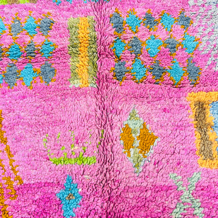 Colorful Berber Moroccan rug with pink, orange, and blue tribal patterns. Handmade wool area carpet for sale.