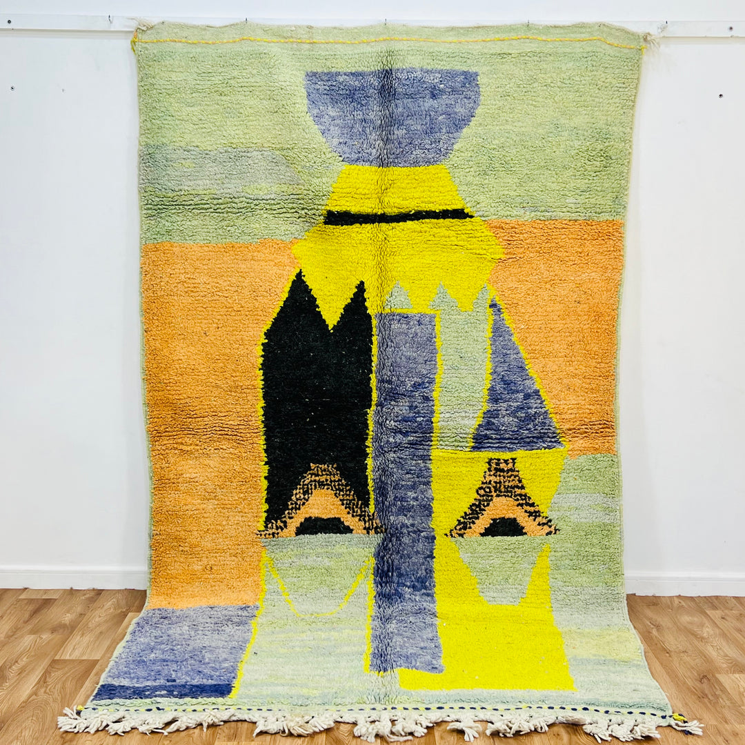 Yellow Moroccan wool rug with abstract tribal vase design in mustard, olive, indigo, black, orange, and lavender hues. 275x168 cm.