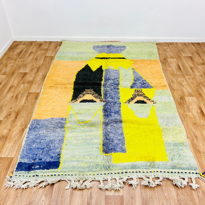 Abstract Moroccan wool rug in yellow, blue, green, and black geometric patterns, 275x168 cm, handmade tribal design.