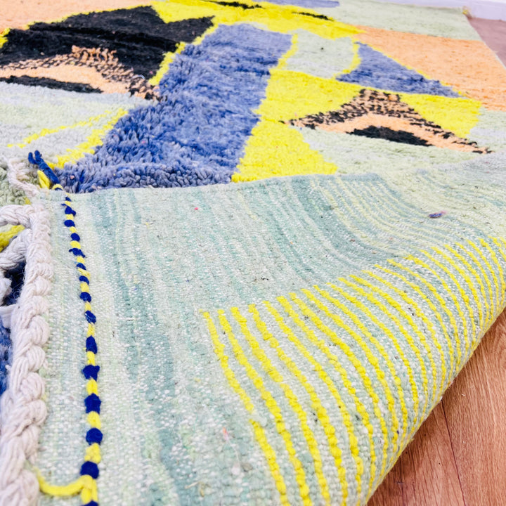 Yellow tribal abstract Moroccan wool rug with geometric designs in indigo and olive, 275x168 cm, handmade Berber style.