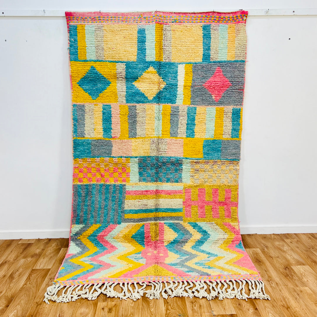 Vintage Moroccan Wool Rug 406 – handmade colorful geometric Moroccan rug in yellow, teal, pink, and gray tones (256 × 150 cm).