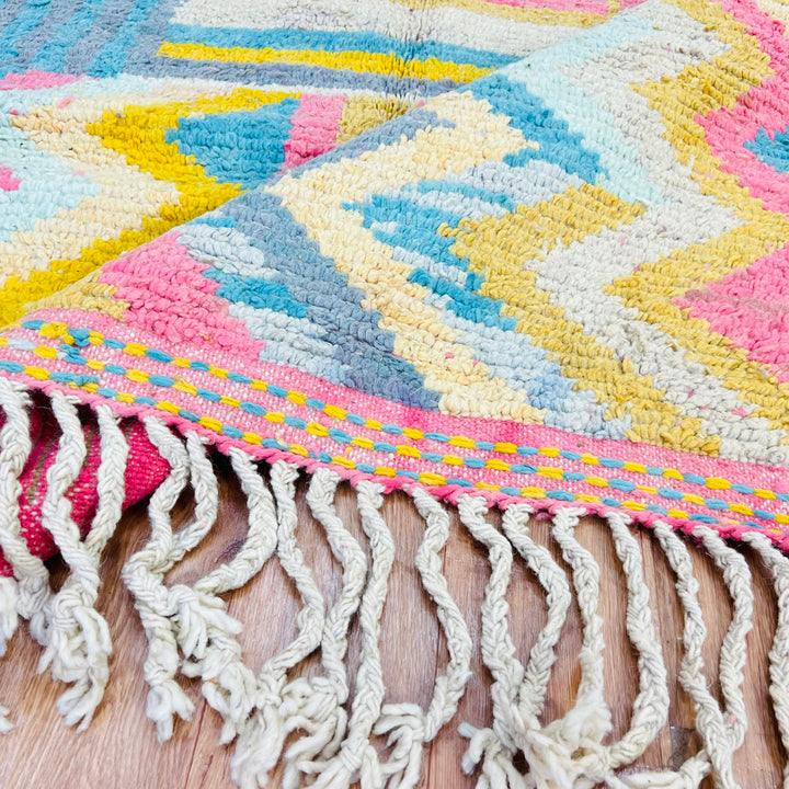 Vintage Moroccan Wool Rug 406 – handmade colorful geometric Moroccan rug in yellow, teal, pink, and gray tones (256 × 150 cm).