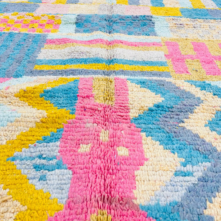 Vintage Moroccan wool rug with colorful Berber patterns in pink, yellow, teal, and grey, handwoven with natural dyes. Moroccan rug 8x10