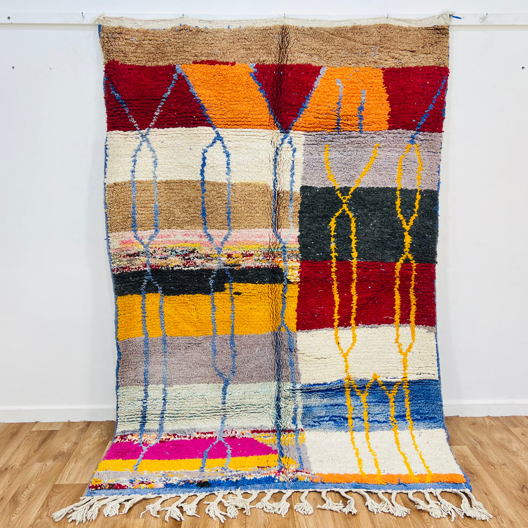 Vintage Moroccan Wool Rug 1003 – handmade colorful geometric Moroccan rug in red, yellow, blue, and cream tones (244 × 168 cm).