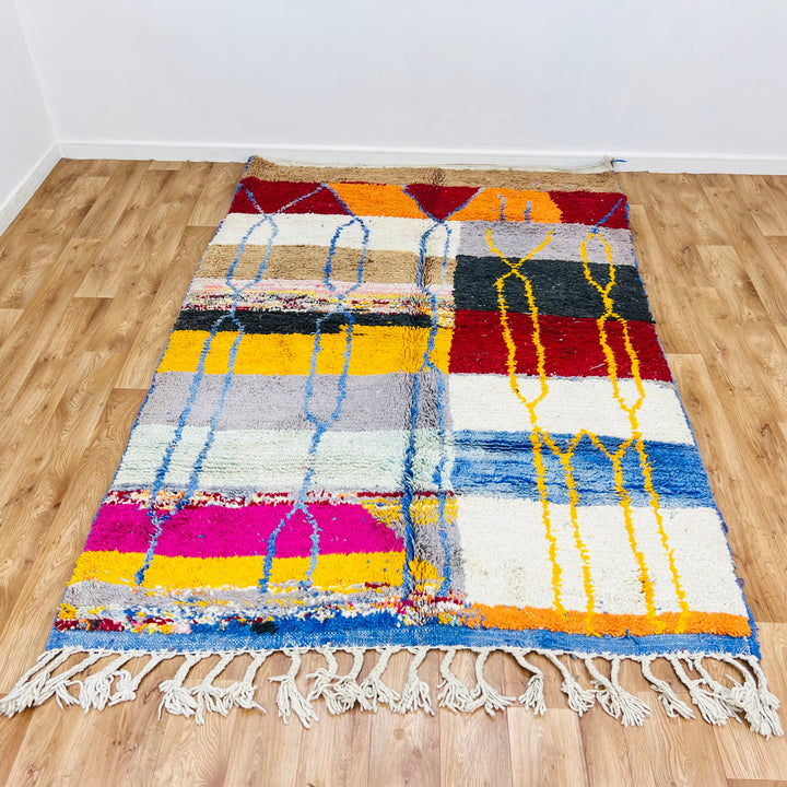Vintage Moroccan Wool Rug 1003 – handmade colorful geometric Moroccan rug in red, yellow, blue, and cream tones (244 × 168 cm).