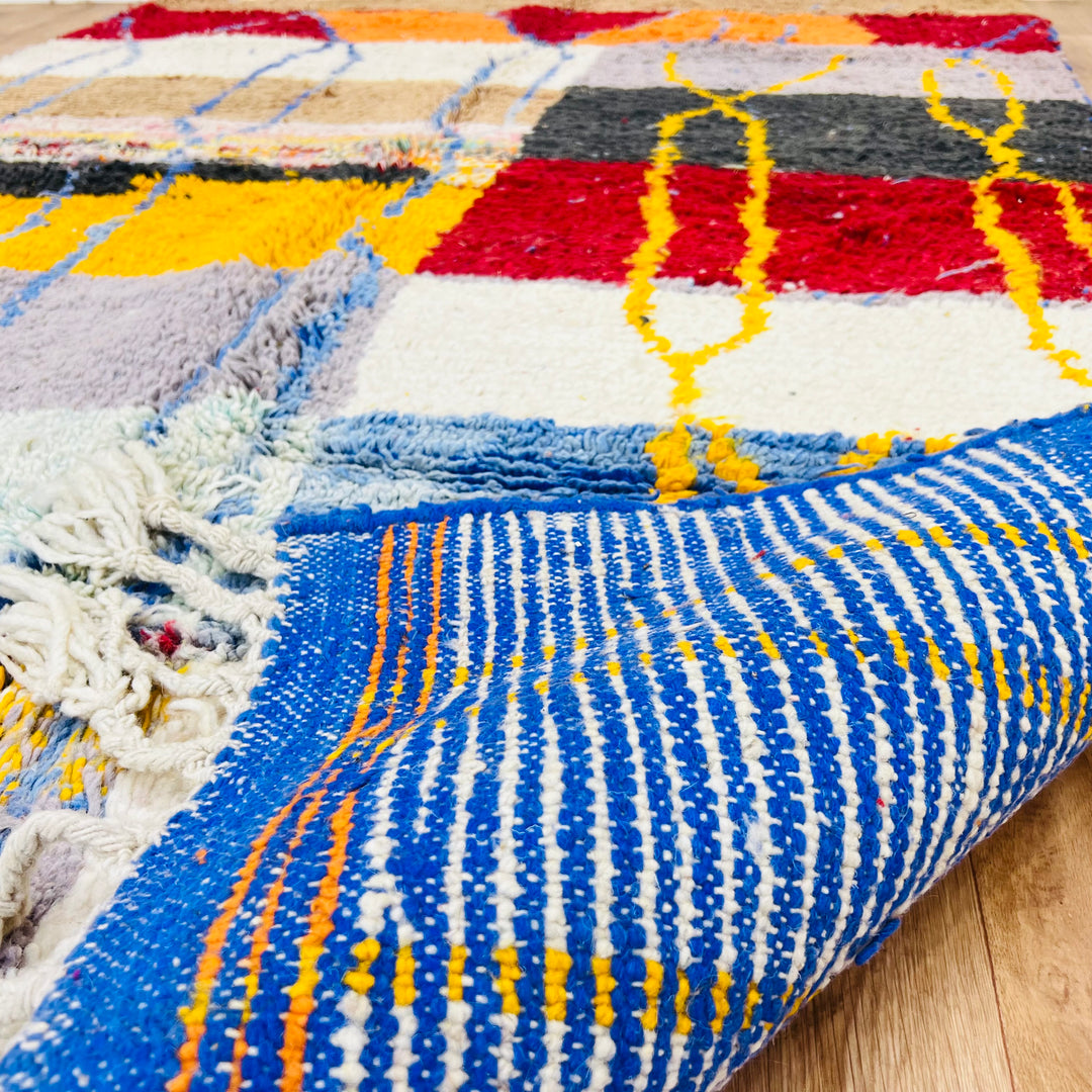 Vintage Moroccan Wool Rug 1003 – handmade colorful geometric Moroccan rug in red, yellow, blue, and cream tones (244 × 168 cm).