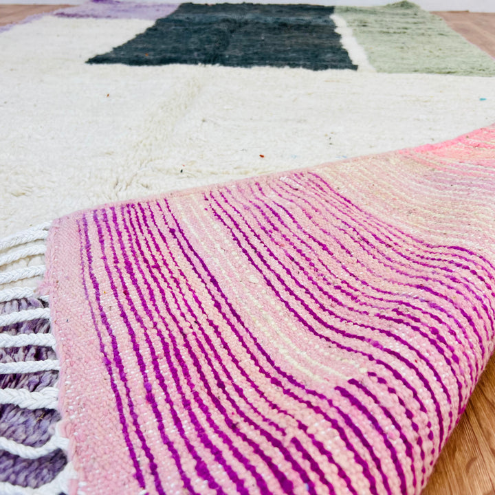 Modern geometric Moroccan rug with oversized blocks in green, sage, purple, and ivory tones, showcasing vintage Berber design.
