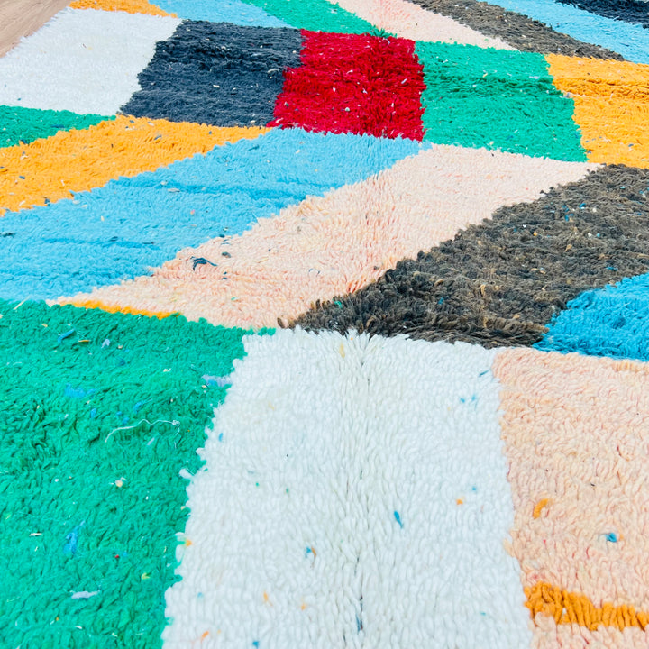 Color block vintage Moroccan Berber rug with vibrant geometric patterns, featuring red, green, sky blue, and ivory tones.