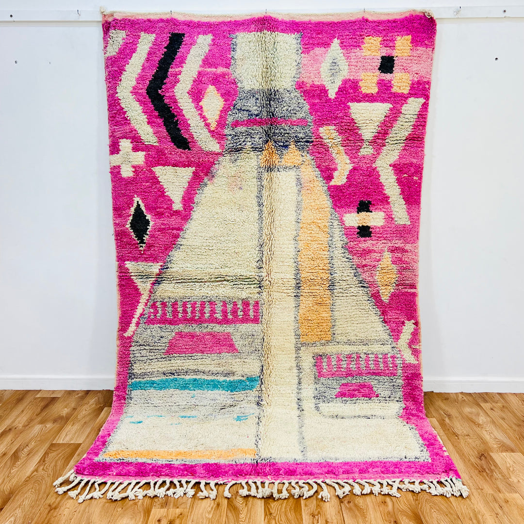 Pink vintage Moroccan rug with tribal patterns, handmade by Berber artisans, evokes ancient symbolism. Size 264x162 cm.