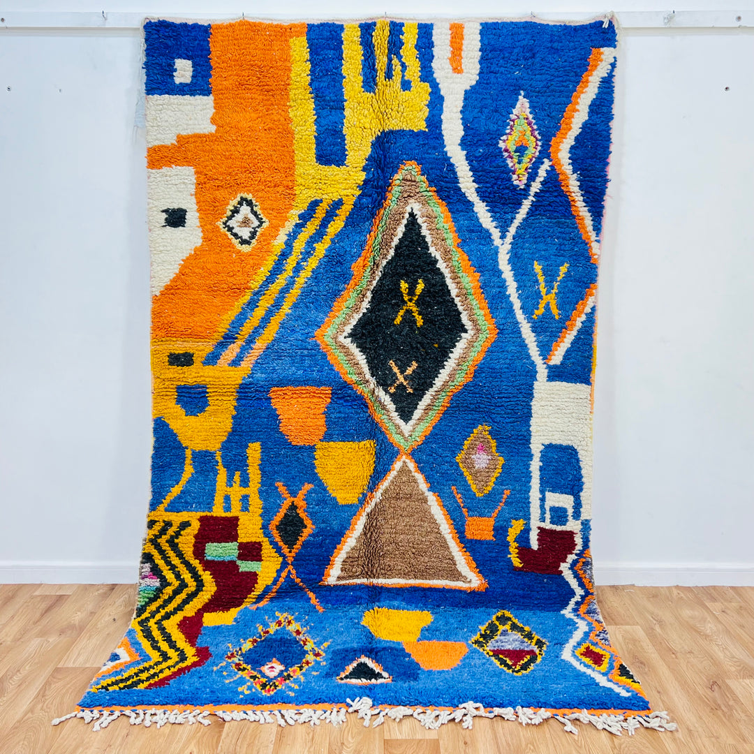 Blue vintage Moroccan rug with vibrant colors and Berber symbols, including diamonds and tribal shapes, 257x160 cm.