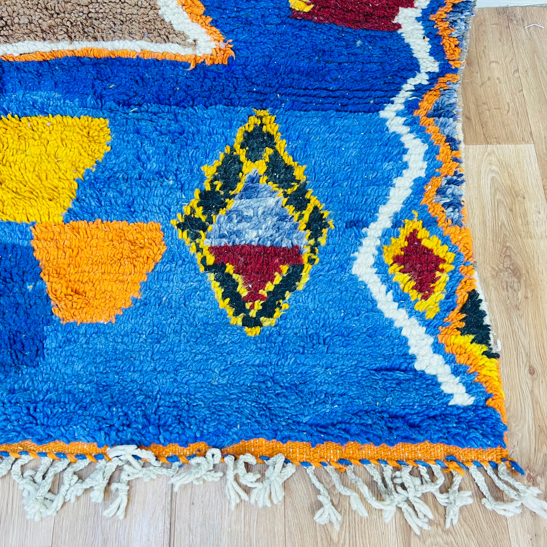 Blue Vintage Moroccan Rug with tribal symbols and vibrant colors, featuring cobalt blue, burnt orange, and bold diamond motifs.