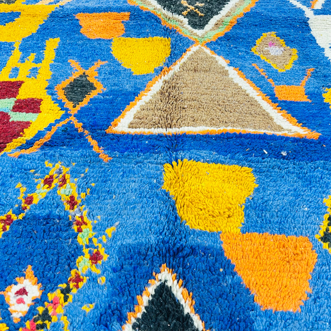 Blue Vintage Moroccan Rug with vibrant tribal patterns, including diamonds and pots, showcasing rich Berber symbols in cobalt blue.