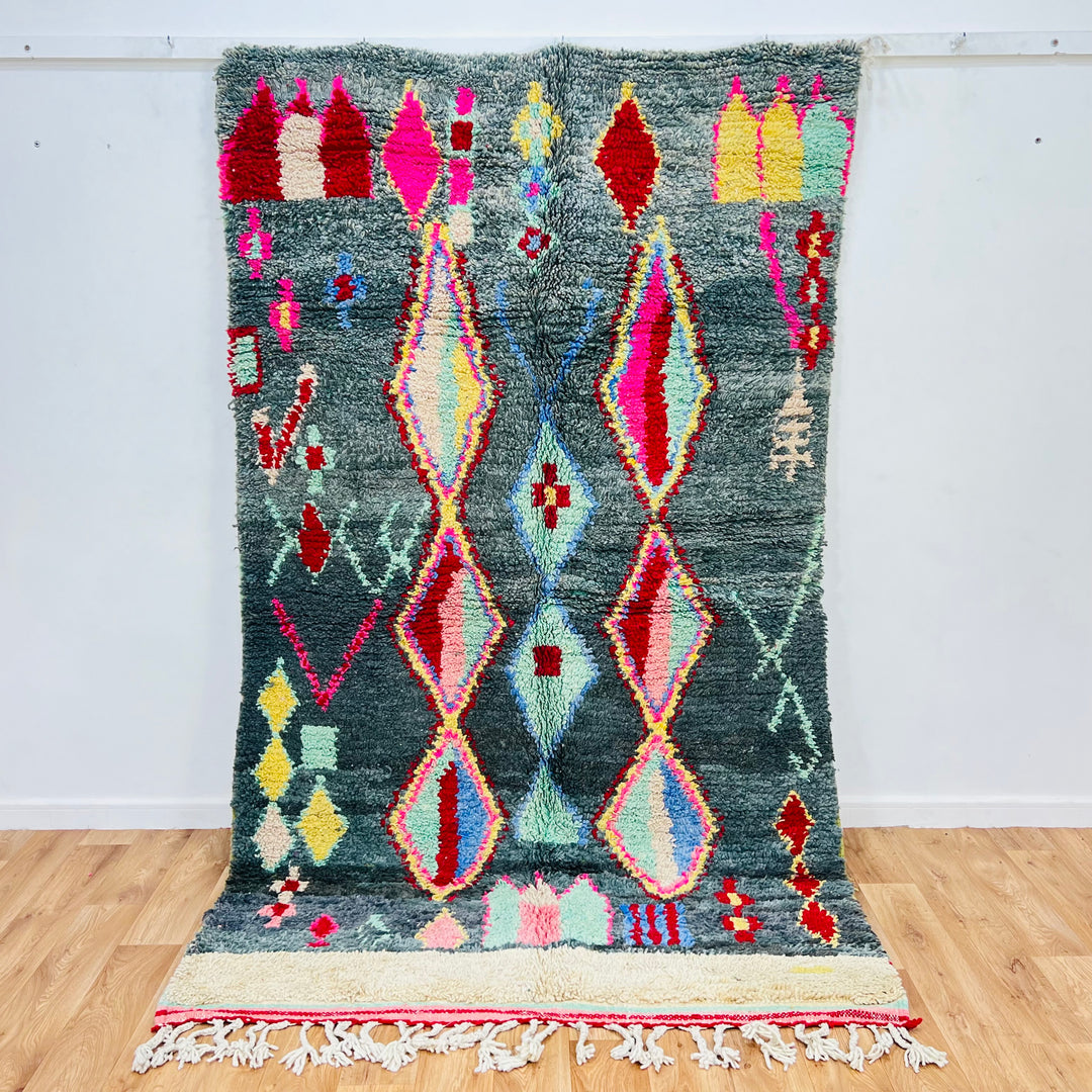 Vintage Moroccan diamond rug with green background, red and pink motifs, and tribal design. Handwoven Berber artisan wool rug.