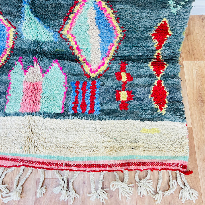 Vintage Moroccan diamond rug with tribal motifs in red, pink, yellow, blue on green; handwoven wool by Berber artisans. 258x151 cm.