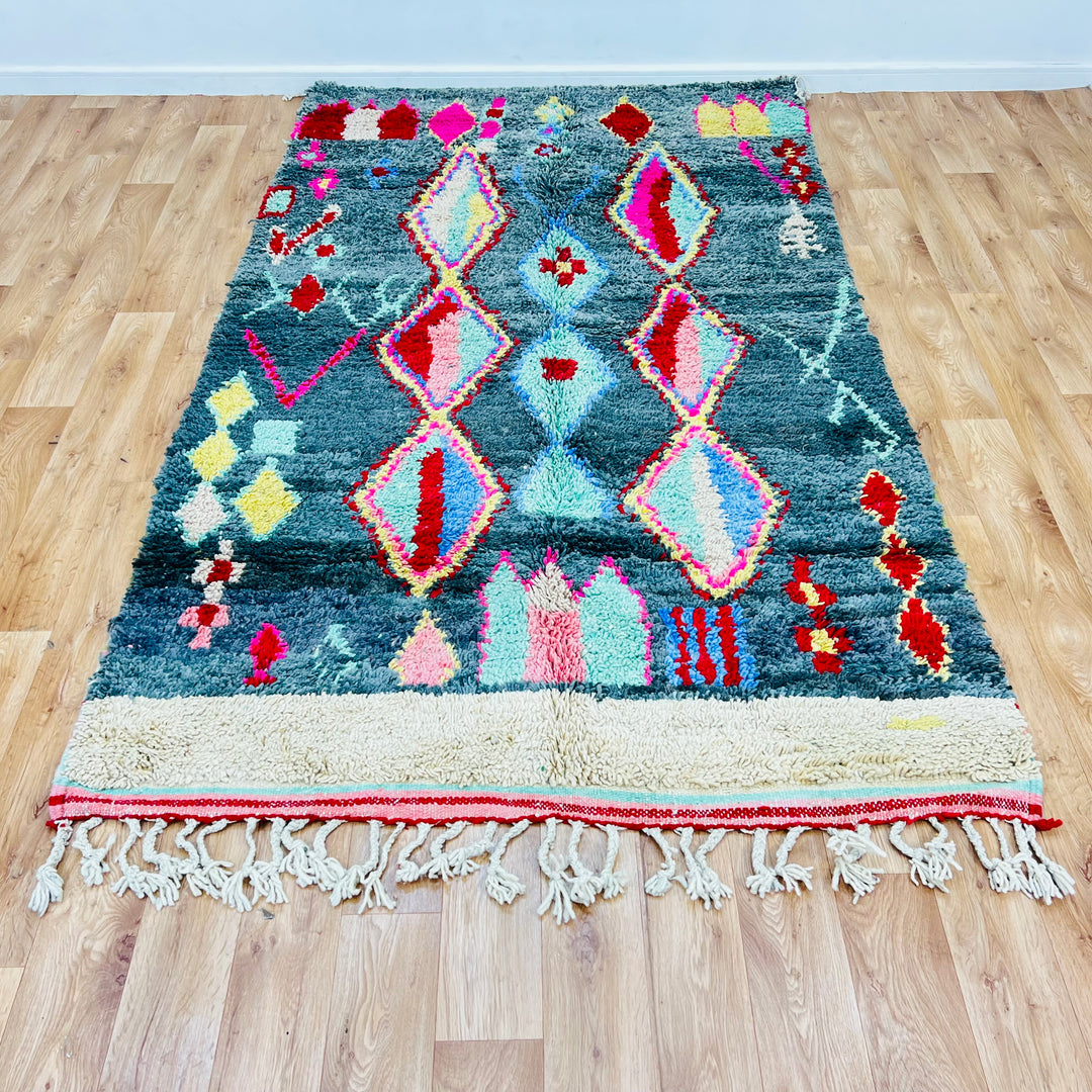 Vintage Moroccan rug with green background and vibrant diamond motifs, 258x151 cm, handwoven by Berber artisans, soft wool.