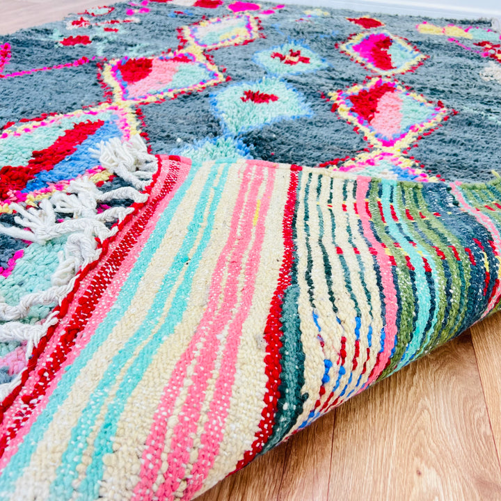 Vintage Moroccan Berber rug with green, red, and pink tribal diamond motifs, 258x151 cm. Handwoven wool rug with fringe detail.