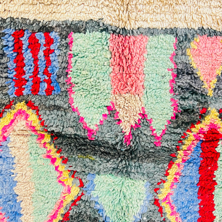 Vintage Moroccan rug with diamond and tribal motifs in green, red, pink, yellow, and blue. Handwoven by Berber artisans. 258x151 cm.