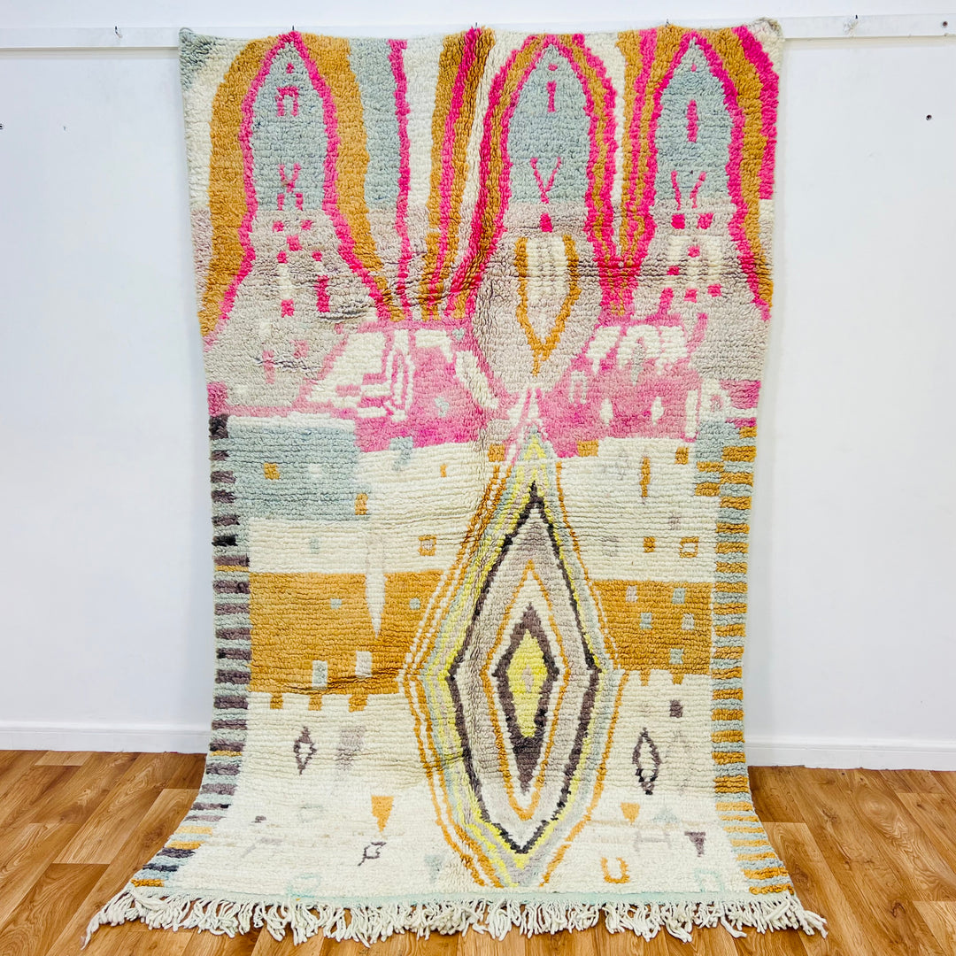 Vintage Moroccan rug with central diamond, pink, gold, gray motifs, handwoven in Atlas Mountains, 246x150 cm.