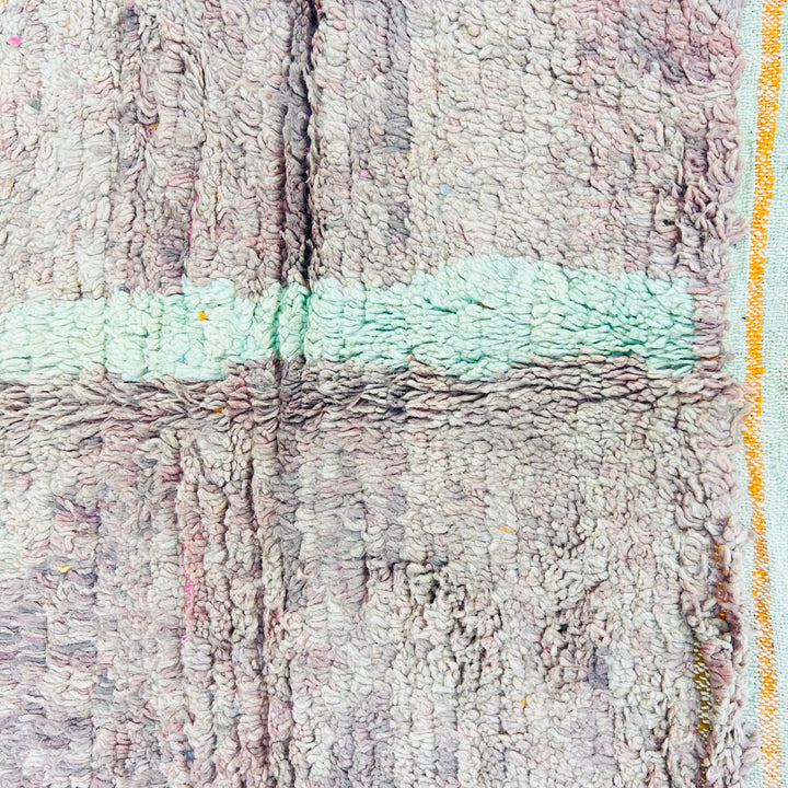 Abstract wool Moroccan rug with earth tones and blue-green accents, showcasing traditional craftsmanship, measuring 229x160 cm.