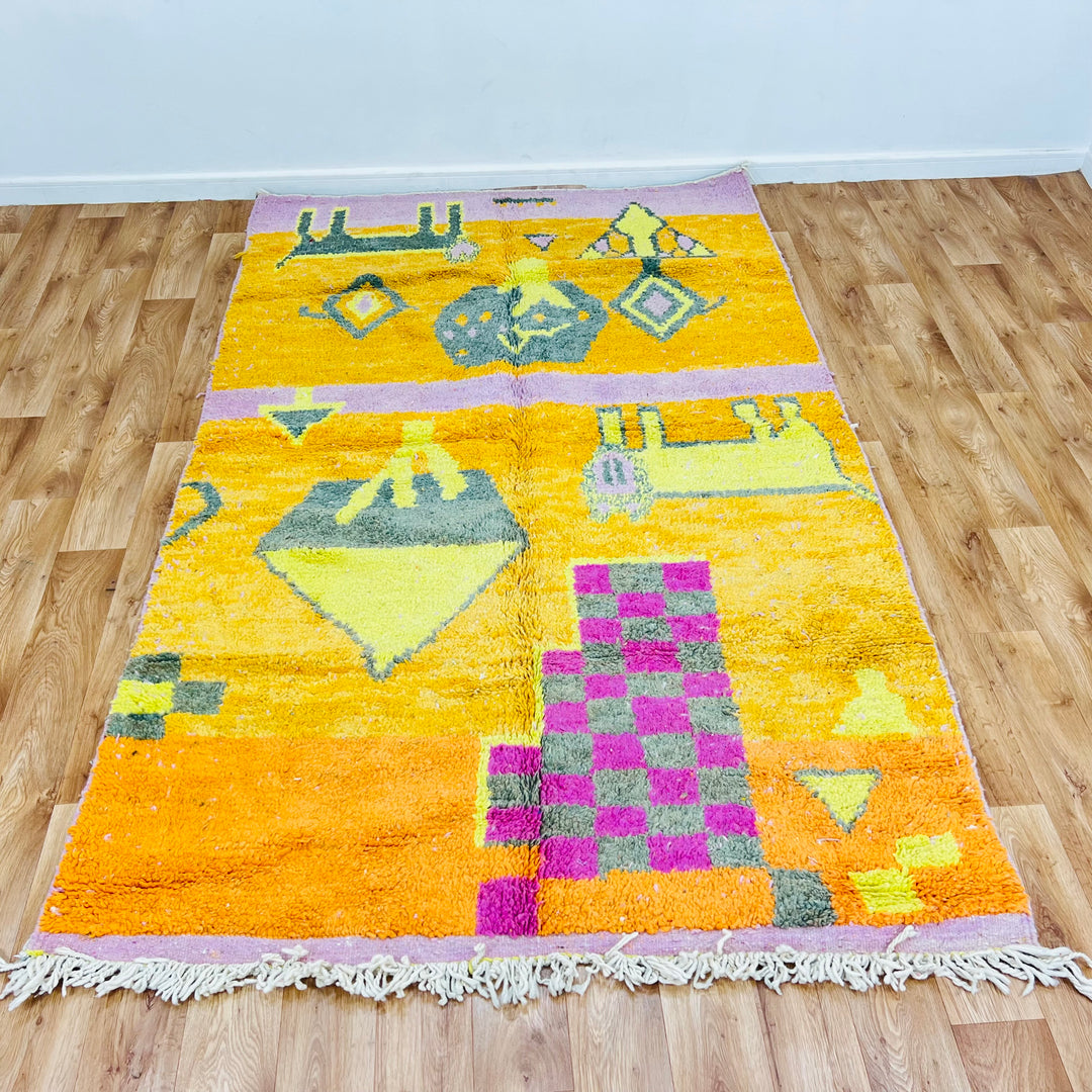 Orange Moroccan Berber rug with pink and grey geometric symbols, checkerboard design, handcrafted by Berber artisans.