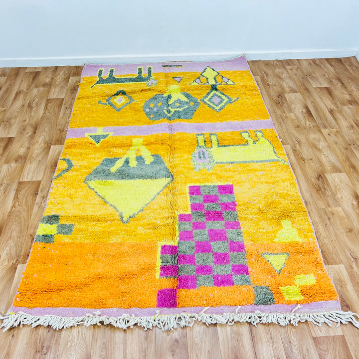 Orange Moroccan Berber rug with pink and grey geometric symbols, checkerboard design, handcrafted by Berber artisans.