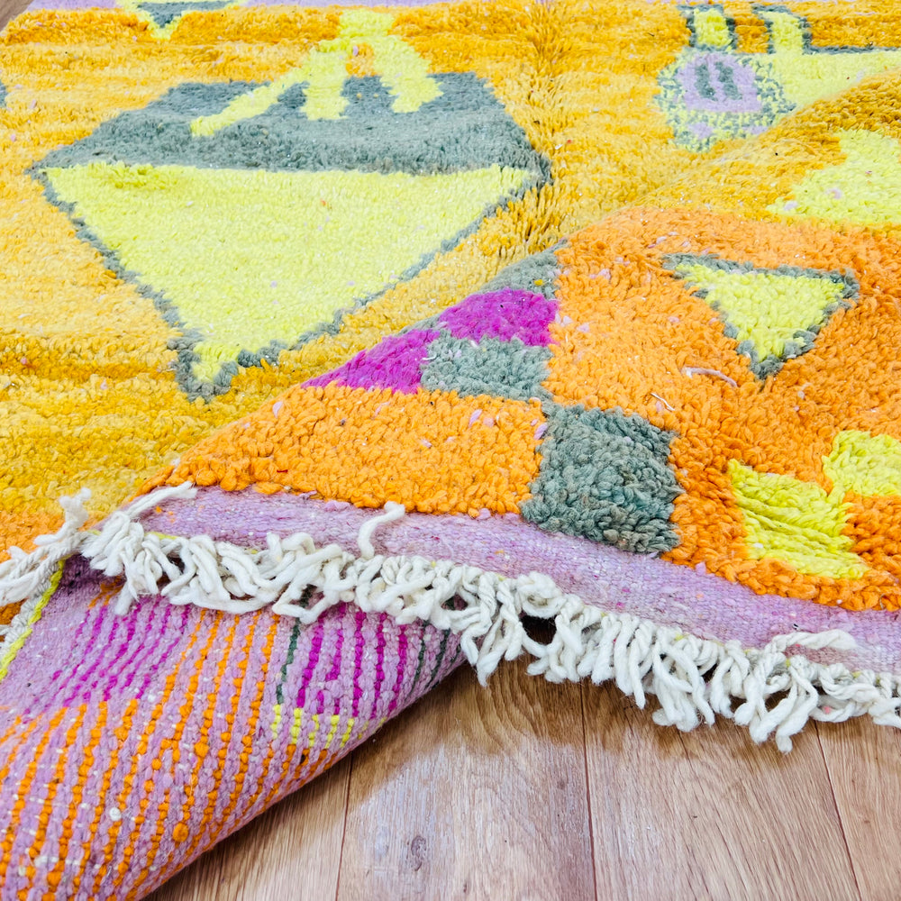 Orange Moroccan Berber rug with pink, yellow, grey geometric symbols and checkerboard, 251x157 cm, traditional Amazigh design.