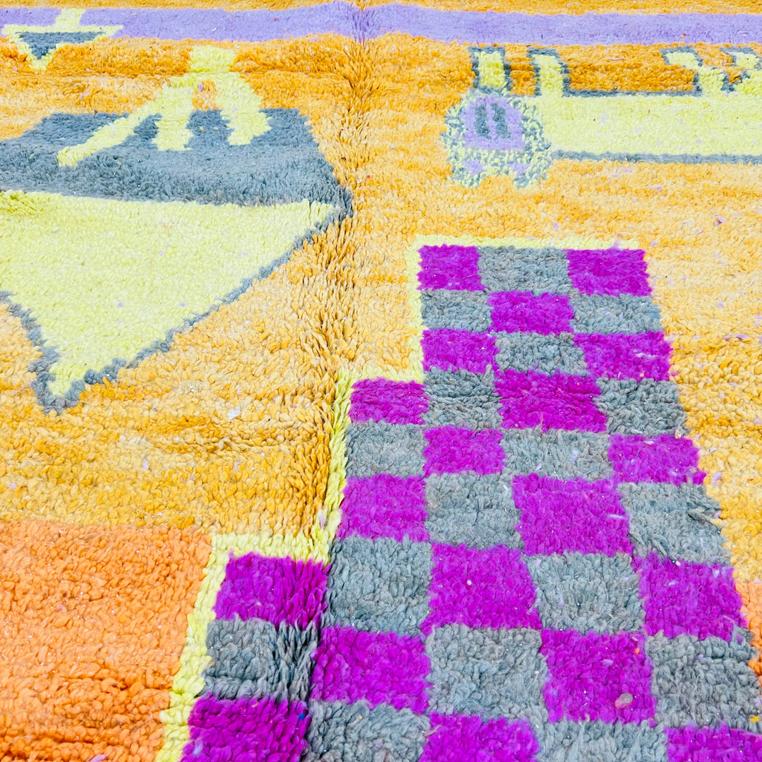 Orange Moroccan Berber rug with pink, yellow, and grey geometric symbols and a bold checkerboard pattern, 251x157 cm.