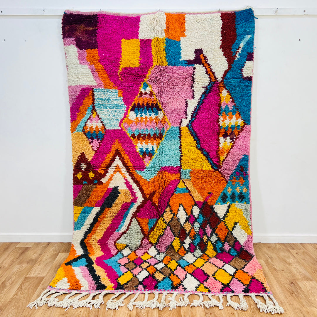 Colorful Moroccan Berber rug with vibrant pink, orange, turquoise patterns, 255x155 cm, handwoven wool, traditional design.