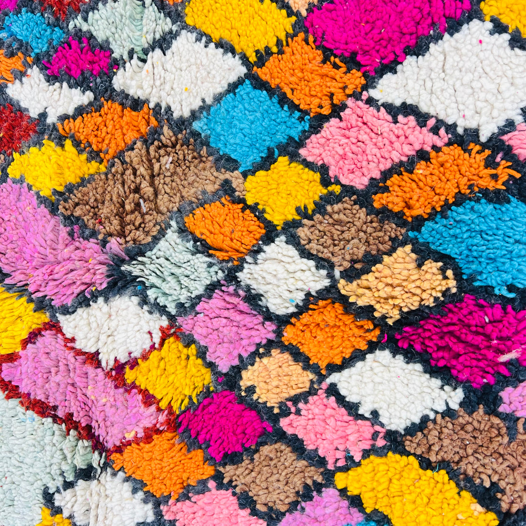 Colorful Moroccan Berber Rug with vibrant diamond patterns in pink, orange, turquoise, and yellow. Handwoven wool rug.