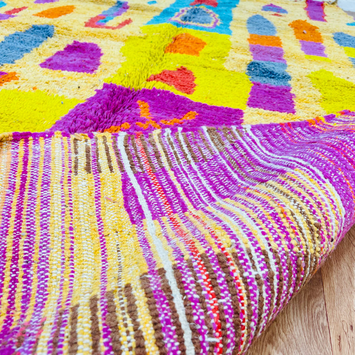 Colorful Moroccan shag rug with vibrant diamonds and patterns in magenta, orange, and aqua. Handmade Berber design, 100% wool.