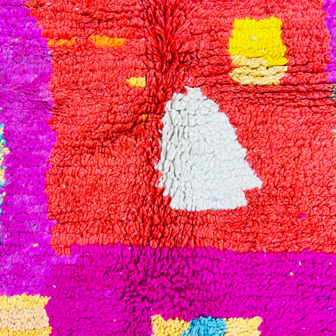 Colorful Moroccan shag rug with vibrant patterns in magenta, orange, and aqua, showcasing traditional Berber design. Handmade wool rug.