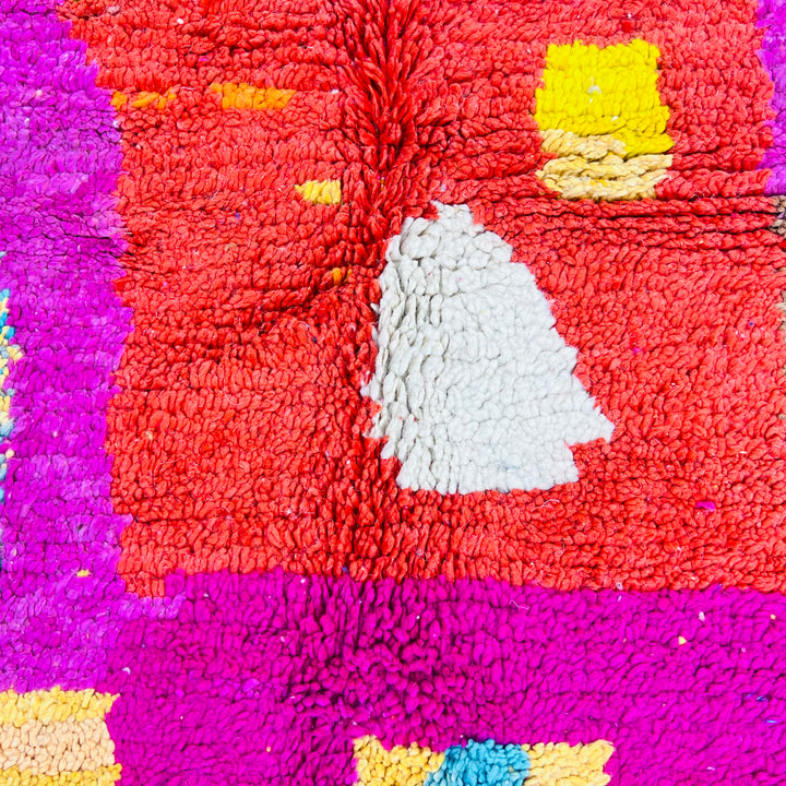 Colorful Moroccan shag rug with vibrant patterns in magenta, orange, and aqua, showcasing traditional Berber design. Handmade wool rug.