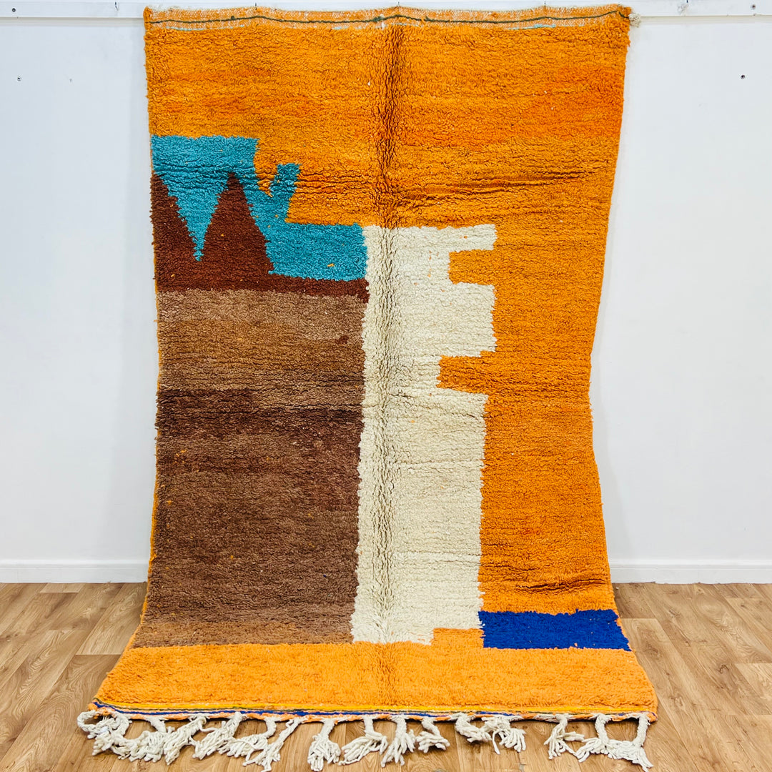 Colorful handmade Moroccan wool rug with abstract motifs in orange, brown, and blue, 251 x 157 cm, traditional Berber design.