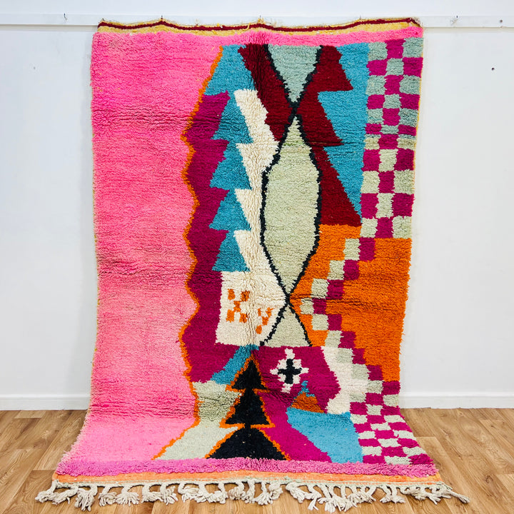 Colorful Moroccan wool rug with vibrant wavy stripes in red, yellow, aqua, pink, grey, and black, handmade by Berber artisans.