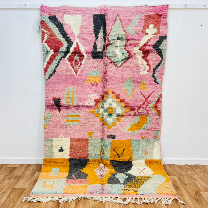 Vintage pink Moroccan rug with geometric and tribal patterns, 248x154 cm, handmade by Berber artisans, rich colors.