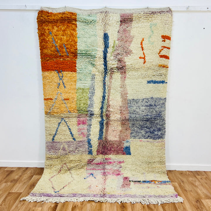 Pastel abstract Moroccan wool rug with colorful geometric patterns, handmade by Berber artisans. Ideal for boho and modern decor.