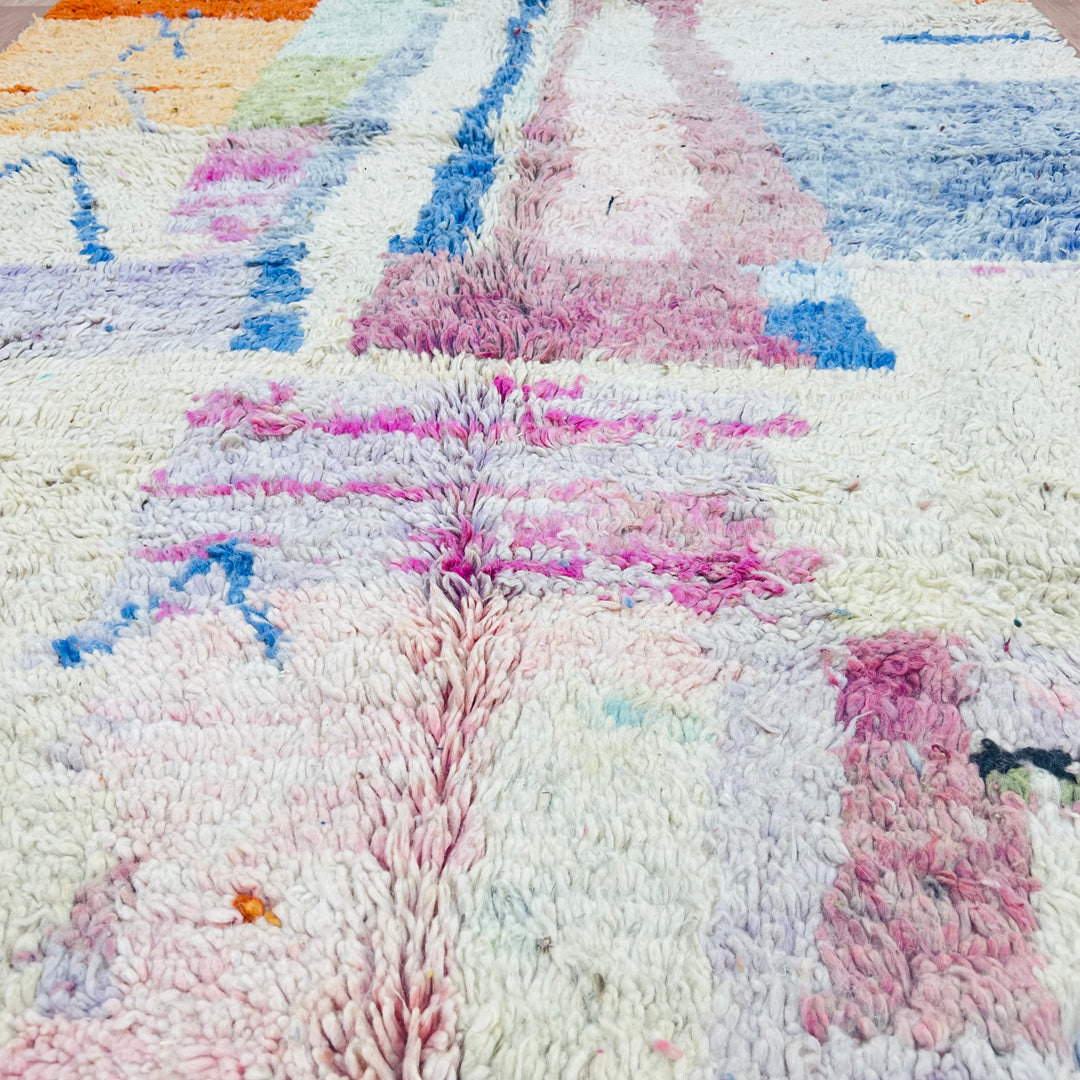 Pastel abstract Moroccan wool rug with pink, blue, and earthy tones, handwoven by Berber artisans. Ideal for modern boho decor.