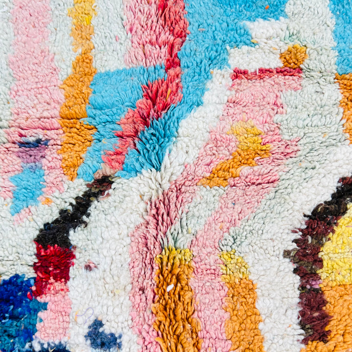 Colorful geometric Moroccan wool rug with pink, blue, orange, and ivory maze-like patterns, 250x163 cm, traditional craftsmanship.
