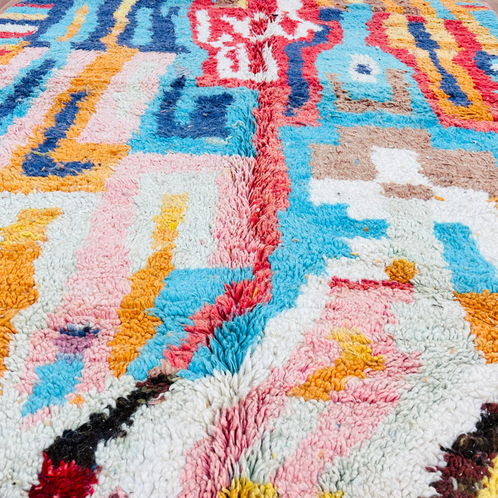 Colorful geometric Moroccan wool rug with orange, blue, red, pink patterns, 250x163 cm, traditional Berber style.