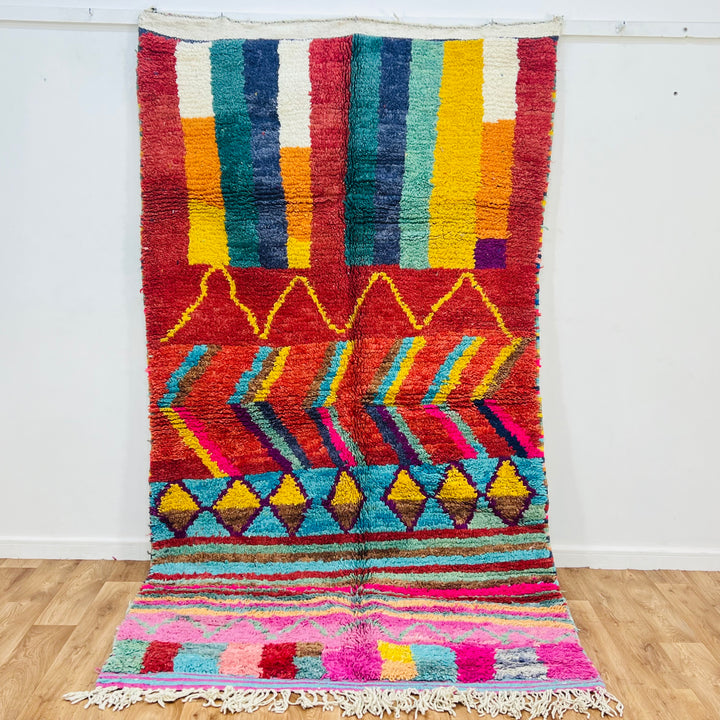 Bold colorful Moroccan Berber rug with geometric patterns, vibrant colors, handmade wool, 274x149 cm, traditional Berber art.