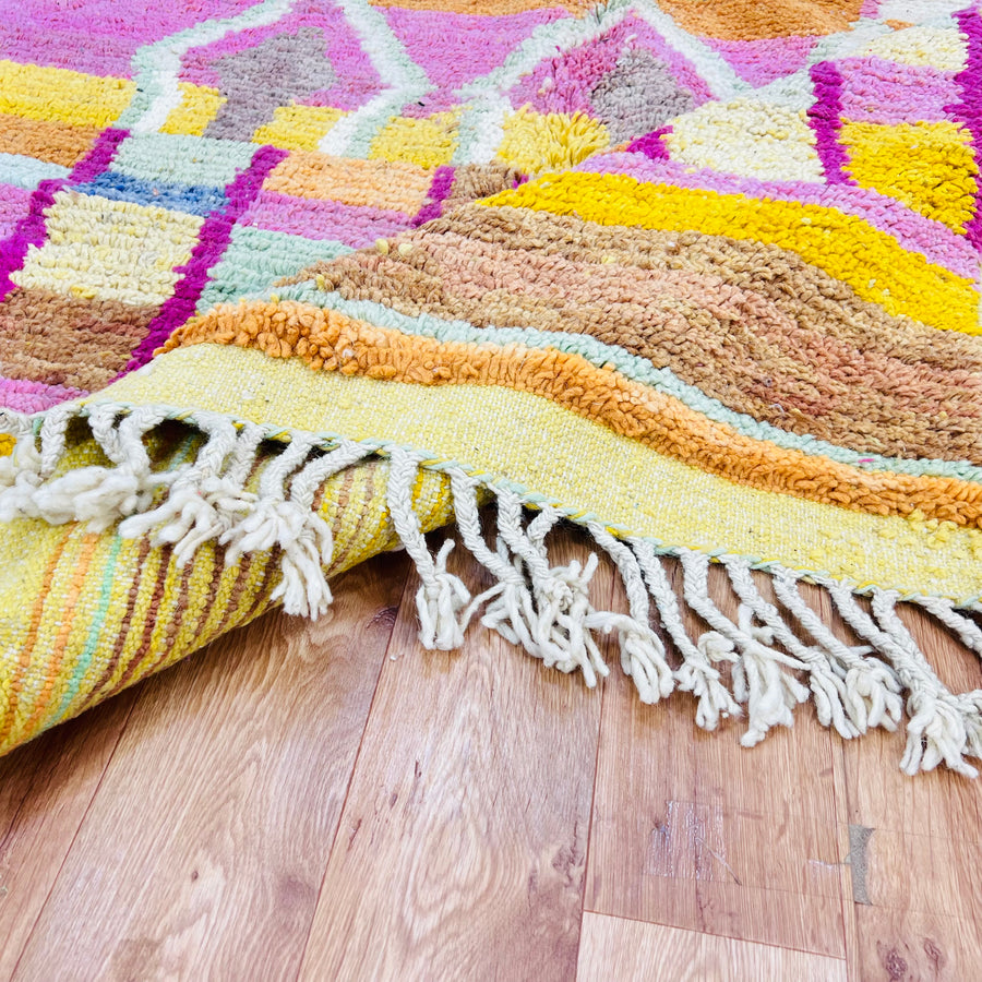 Colorful Moroccan wool rug with yellow, pink, orange diamonds, handmade Berber style, 260 x 158 cm, vibrant and plush.