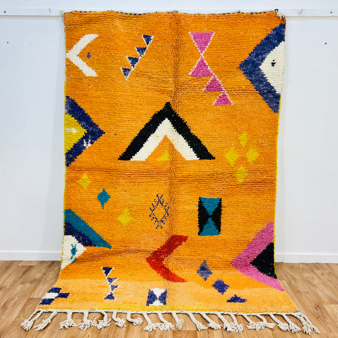 Orange Moroccan Wool Rug with Berber motifs, 246x167 cm, featuring geometric patterns in black, pink, blue, red, yellow, ivory.