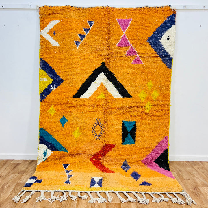 Handmade orange Moroccan wool rug with tribal Berber motifs, 246x167 cm, featuring geometric patterns and vibrant colors.