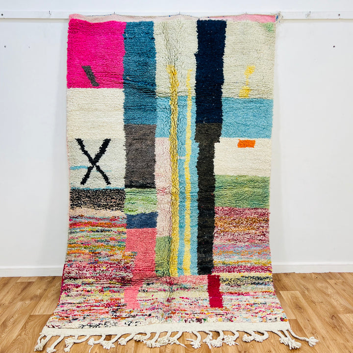 Colorful Moroccan Berber wool rug with vibrant abstract patterns in pink, blue, black, green, and cream, size 247x154cm.